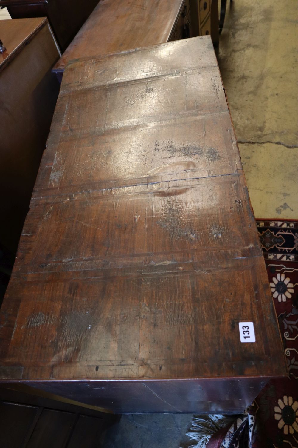 An early to mid 18th century chest with later top, two short and three long drawers, on later bun feet, width 101cm